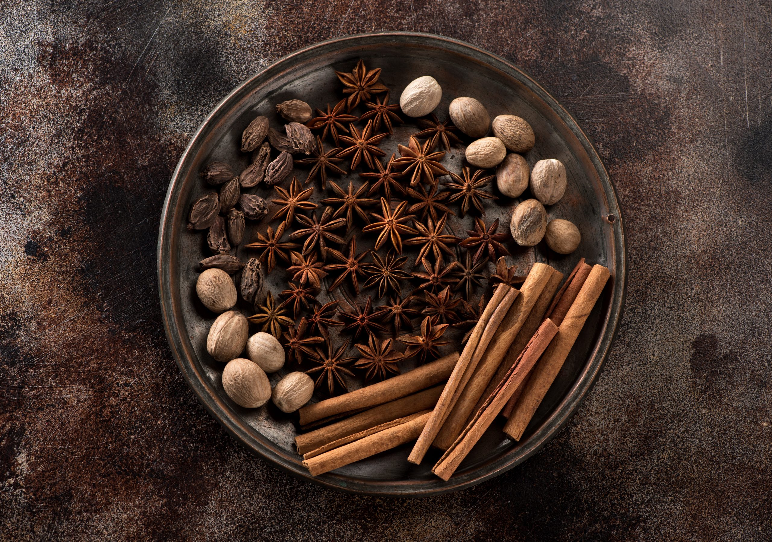 spicy-and-spices-star-anise-cinnamon-sticks-nut-2022-02-28-22-18-44-utc Spicy and spices. Star anise, cinnamon sticks, nutmeg and black cardamom In a vintage copper tray